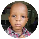 Daniel, a young boy in a red checked shirt.