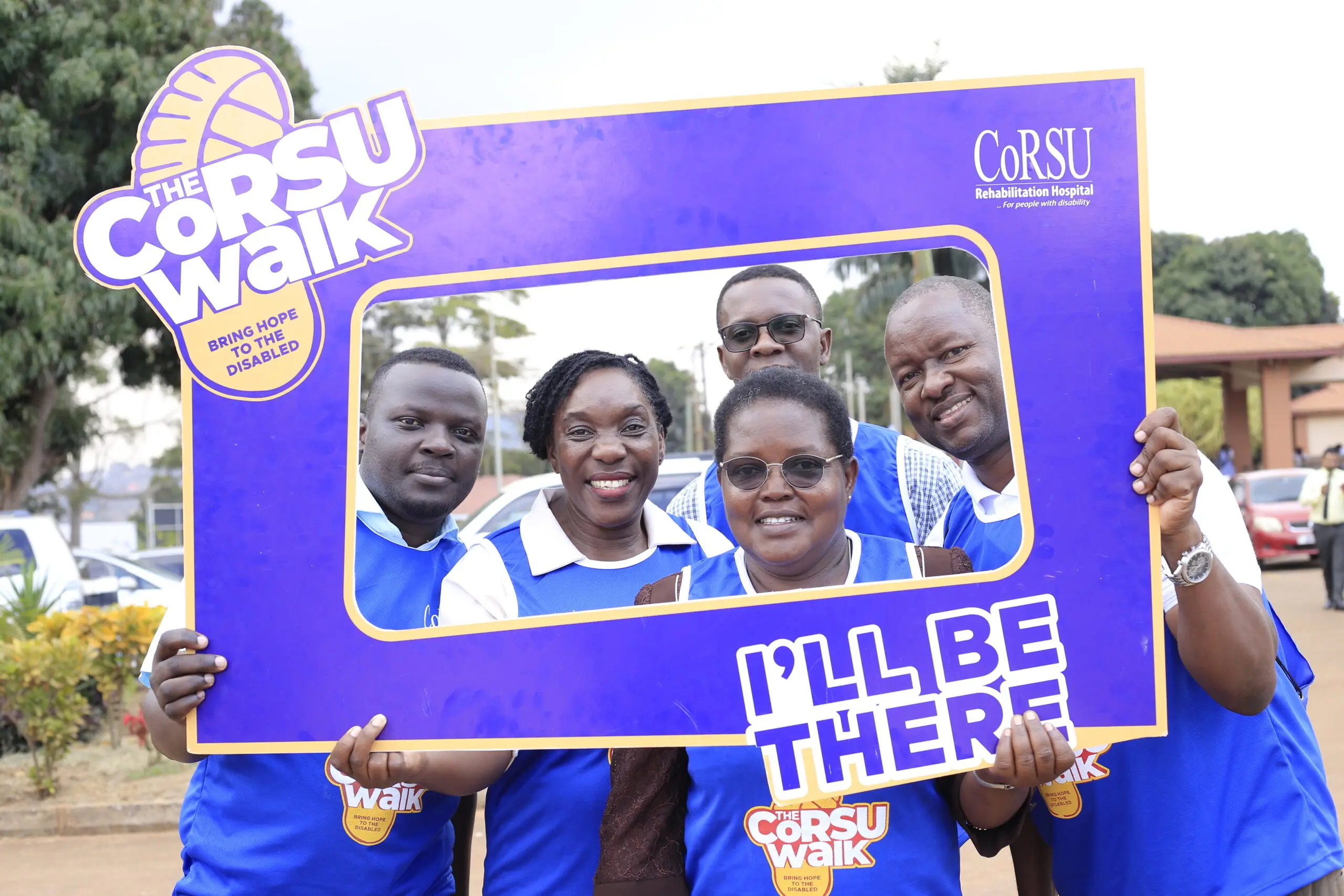 Four smiling CoRSU staff members pose together outdoors.